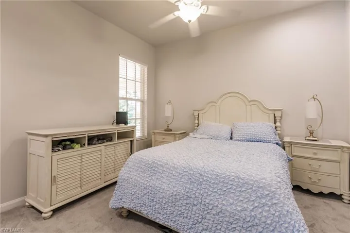 Carpeted bedroom with ceiling fan