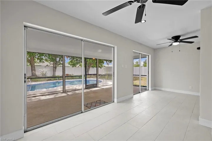 Empty room with a ceiling fan and baseboards