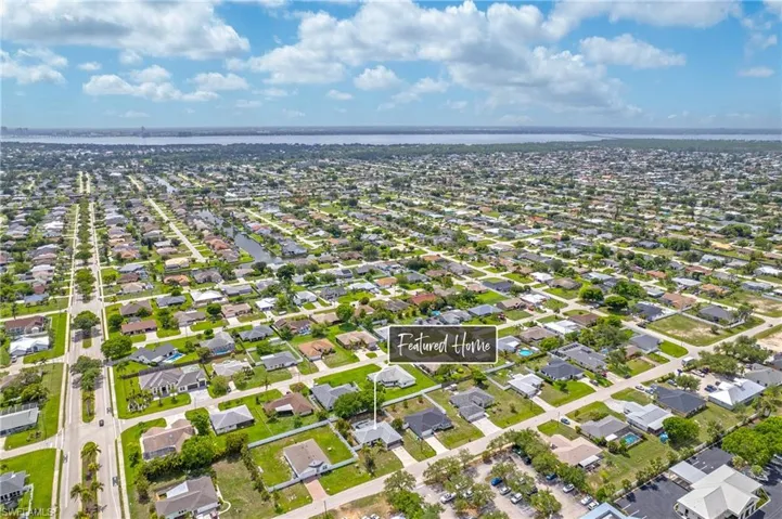 Aerial view of property's location with nearby suburban area and a large body of water