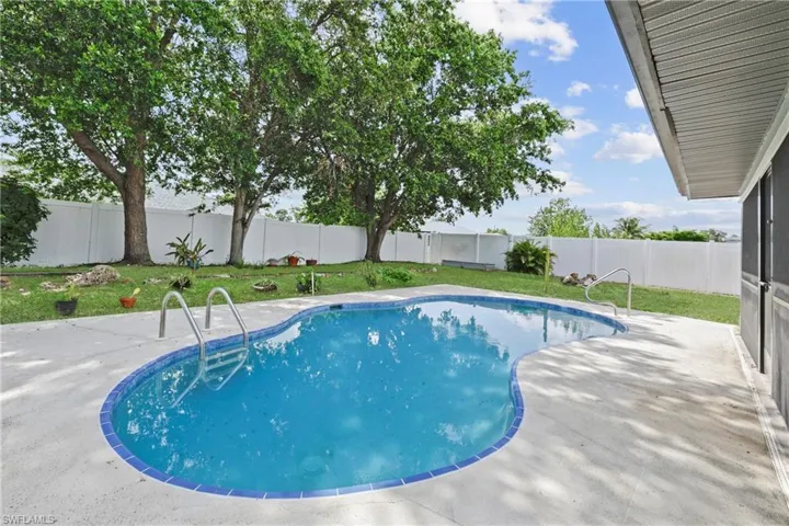 View of pool with a fenced backyard and a patio