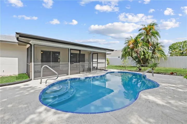 View of pool featuring a sunroom and a patio area