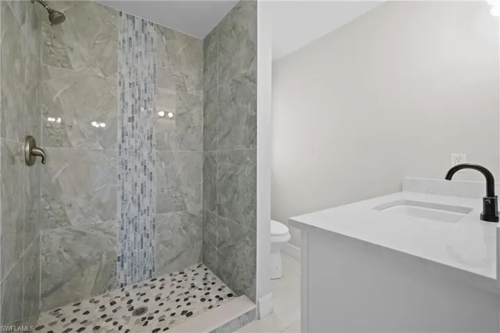 Bathroom with a stall shower and vanity