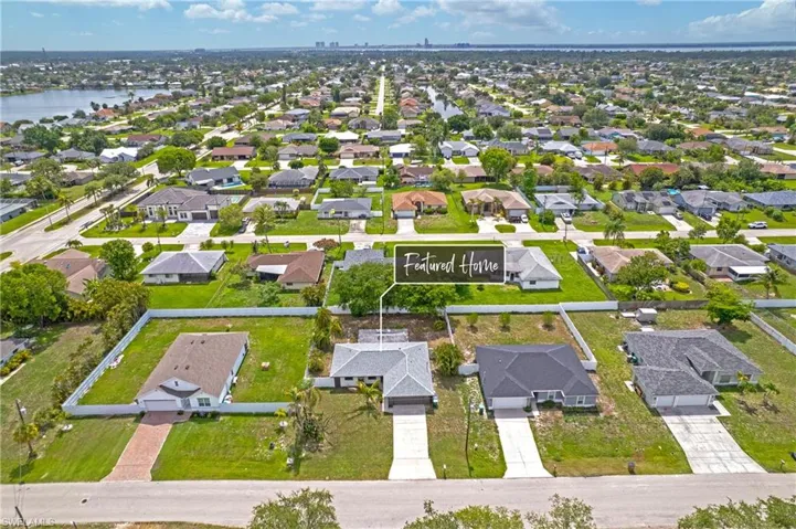 Aerial view of residential area featuring a nearby body of water