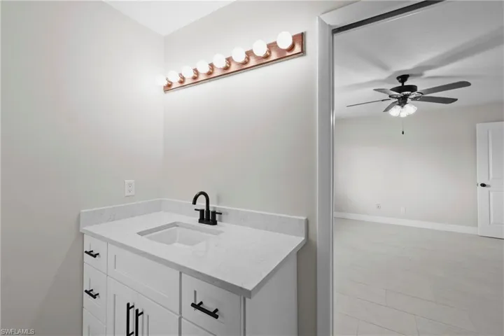 Bathroom with vanity and ceiling fan