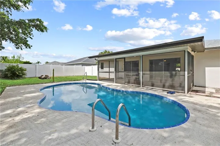View of swimming pool with a sunroom, a fenced backyard, and a patio