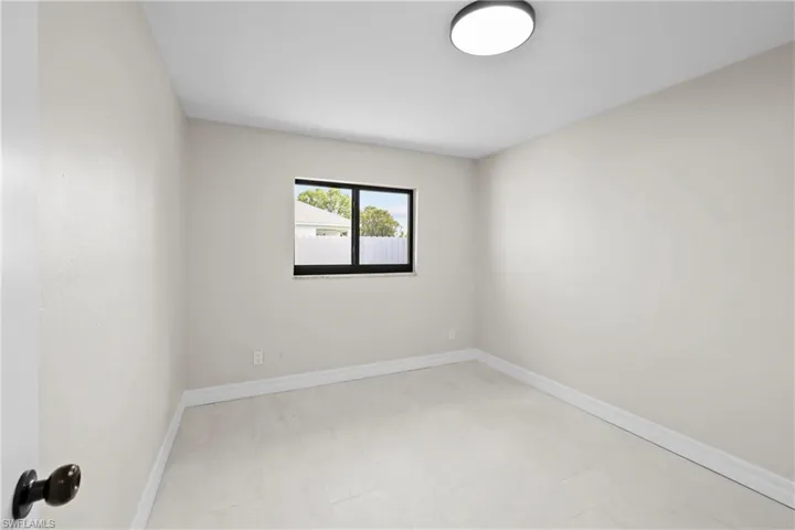 Spare room featuring baseboards