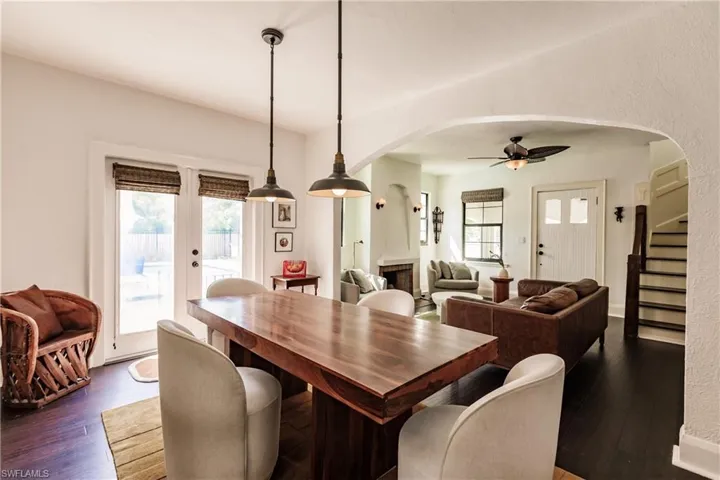 Dining area with a fireplace, dark hardwood / wood-style floors, and ceiling fan
