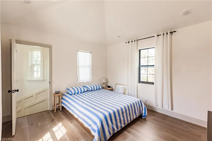Bedroom with multiple windows and hardwood / wood-style flooring