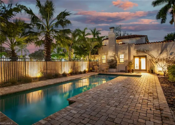 Pool at dusk with a patio area