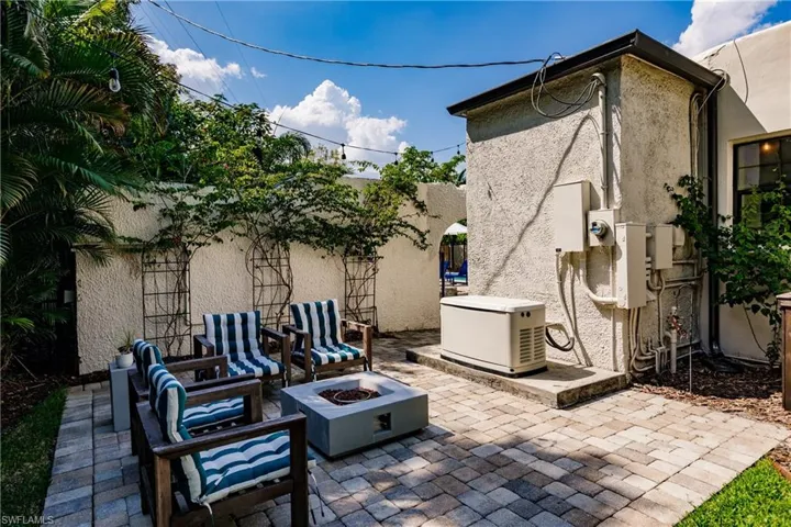 View of patio with an outdoor fire pit