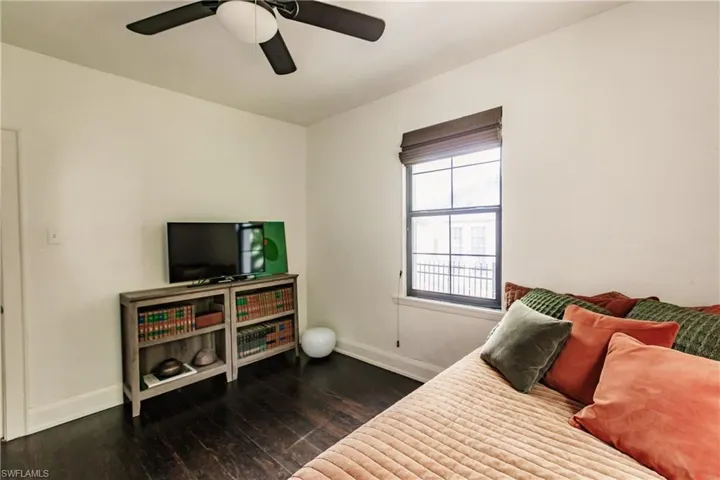 Bedroom featuring dark wood-type flooring and ceiling fan