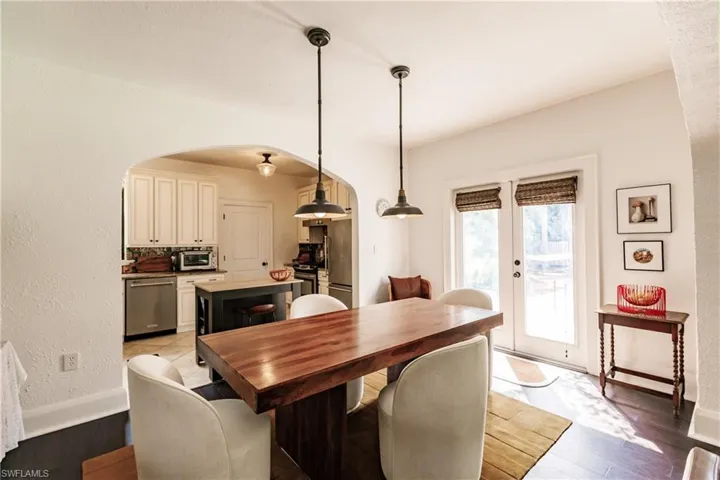 Dining space with light hardwood / wood-style flooring and french doors