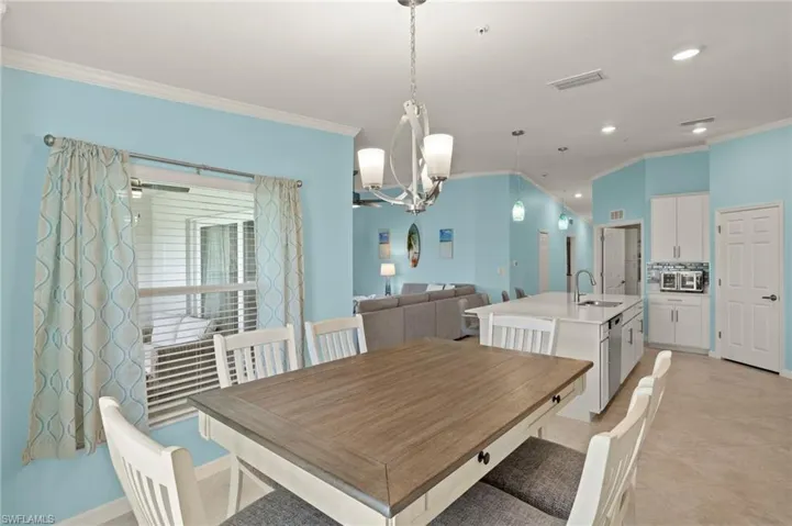 Dining space featuring crown molding, a chandelier, and recessed lighting