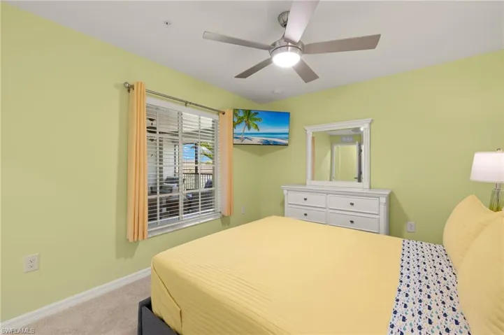 Bedroom with carpet flooring, baseboards, and ceiling fan