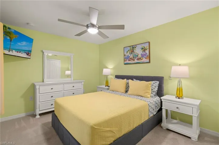 Bedroom with carpet, baseboards, and a ceiling fan