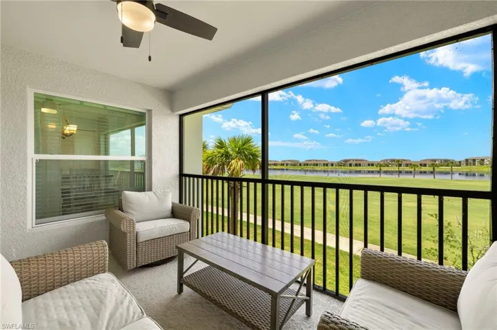 Sunroom / solarium with a water view, ceiling fan, and healthy amount of natural light