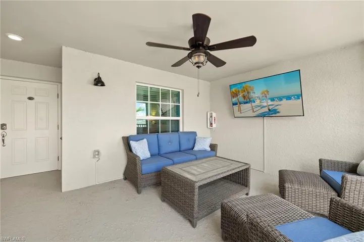 View of patio featuring an outdoor hangout area and a ceiling fan