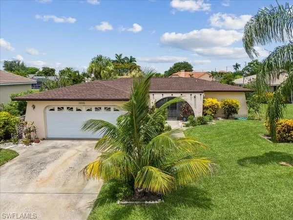 View of front of home with a garage and a front yard