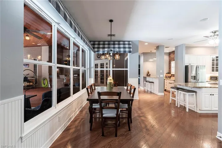 Dining space featuring ceiling fan and dark wood-type flooring