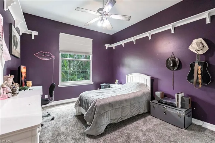 Bedroom featuring ceiling fan and carpet floors