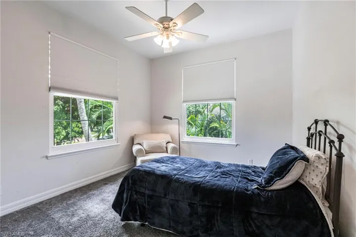 Bedroom with ceiling fan and carpet