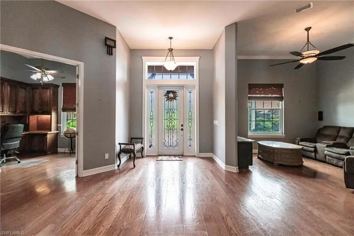 Entrance foyer with hardwood / wood-style floors and ceiling fan