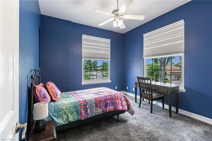 Bedroom with ceiling fan and carpet