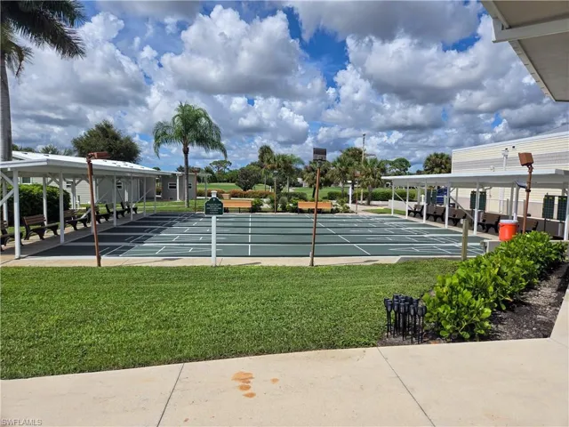 Shuffleboard courts featuring multiple playing areas, shaded seating, and integrated lighting