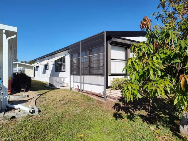 White siding exterior with a black trim roofline
