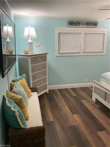 Wood-finish flooring provides a warm foundation for this space, complemented by light blue walls