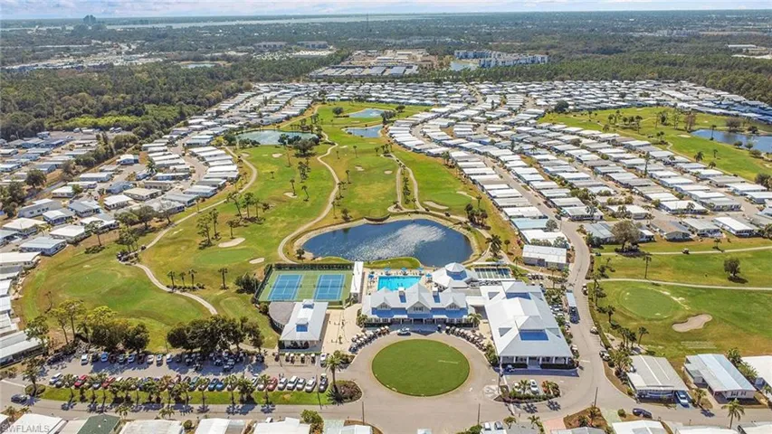 Extensive golf course community featuring multiple water features, tennis courts, and a central clubhouse with a swimming pool
