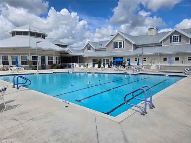Outdoor swimming pool with integrated lap lanes and concrete decking