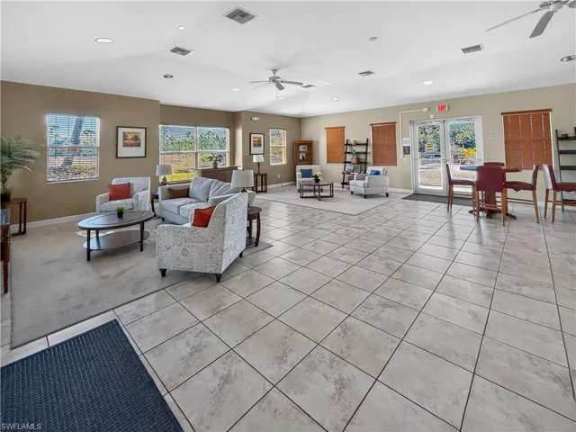 Living room with a ceiling fan, tile patterned flooring, healthy amount of natural light, and recessed lighting