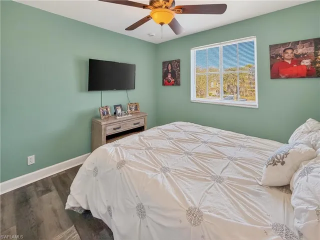 Bedroom with a ceiling fan and wood finished floors
