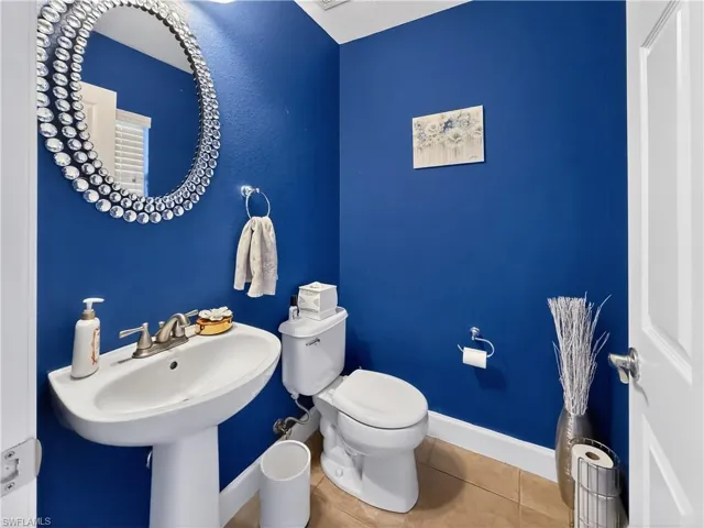 Bathroom featuring toilet and tile patterned flooring
