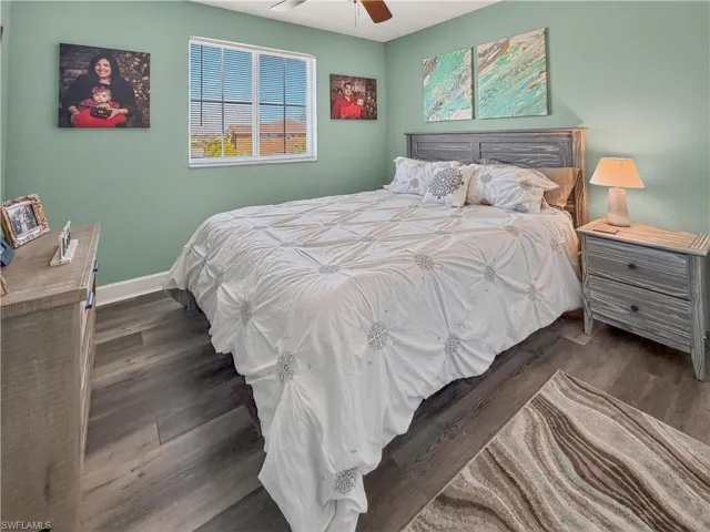 Bedroom with dark wood-style flooring and ceiling fan
