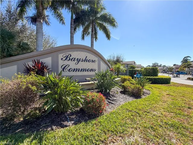 Community / neighborhood sign featuring a lawn