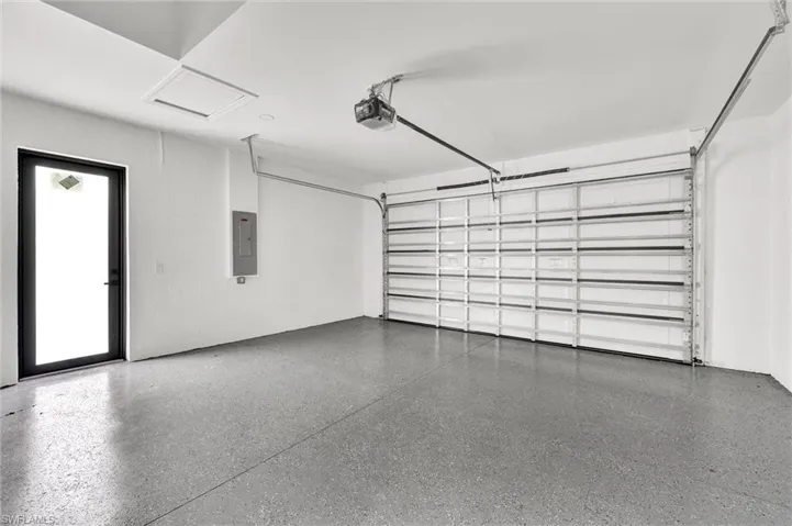 Garage with electric panel and a garage door opener