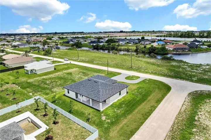 Aerial perspective of suburban area with a nearby body of water
