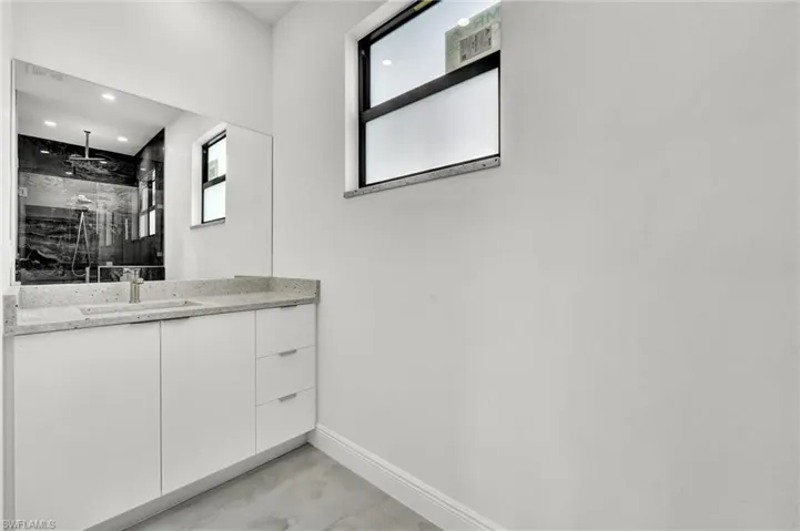 Bathroom with vanity, walk in shower, and recessed lighting