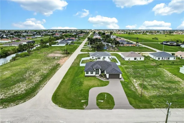 Aerial perspective of suburban area with a nearby body of water