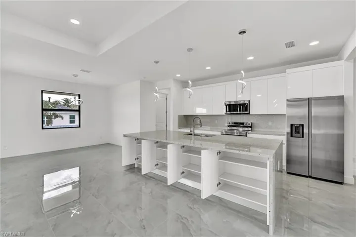 Kitchen with open shelves, stainless steel appliances, recessed lighting, white cabinetry, and tasteful backsplash
