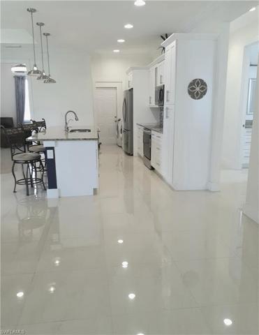 Recessed lighting illuminates the beautiful tile flooring