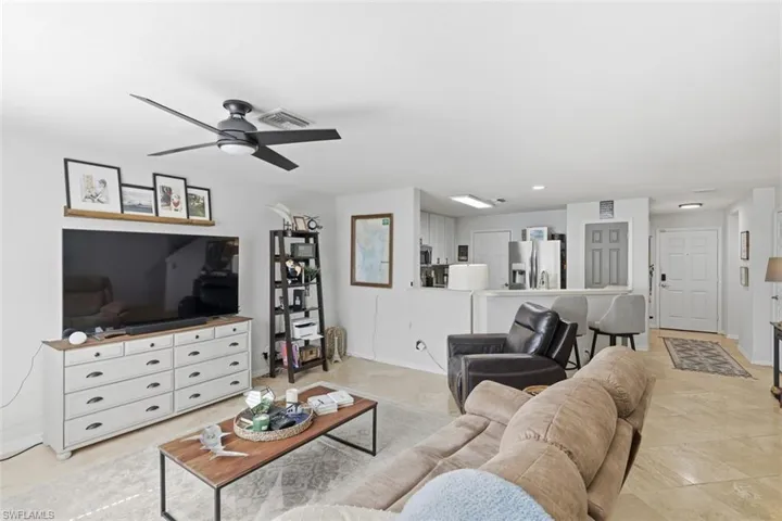 Living room with a ceiling fan and recessed lighting