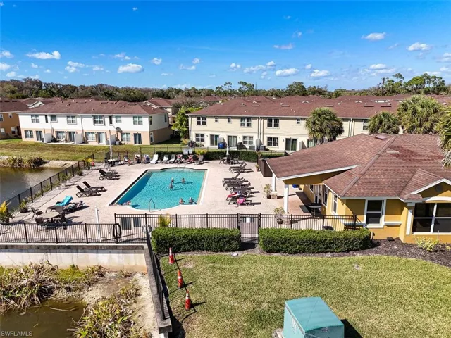 Community pool featuring a patio area and a water view