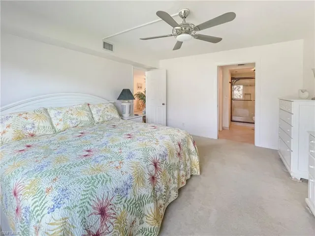 Bedroom featuring ceiling fan and light carpet