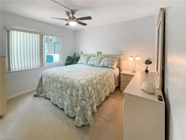 Bedroom featuring light colored carpet and ceiling fan