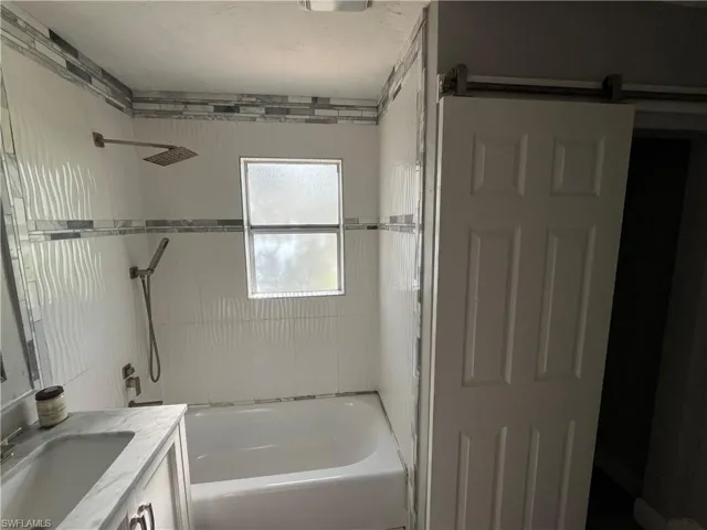 Bathroom with vanity and  shower combination