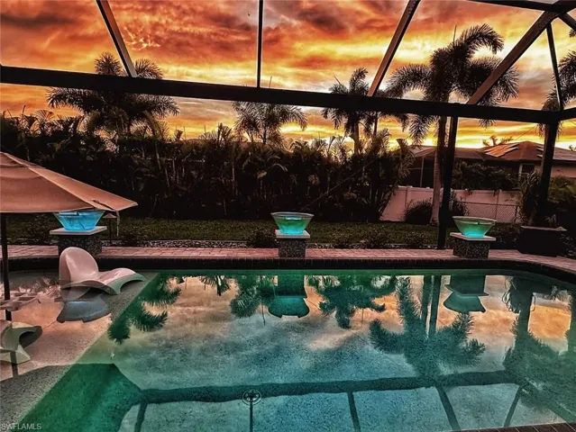 Pool at dusk with glass enclosure