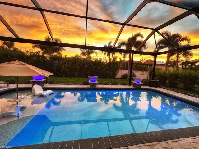 Pool at dusk with glass enclosure
